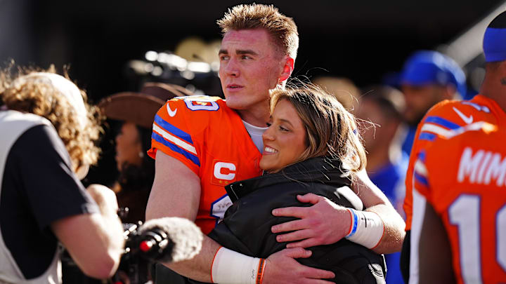 Jan 4, 2026; Denver, Colorado, USA; Denver Broncos quarterback Bo Nix (10) hugs wife, Izzy Nix before the game against the Los Angeles Chargers at Empower Field at Mile High. 