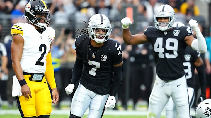 Oct 13, 2024; Paradise, Nevada, USA; Las Vegas Raiders safety Tre'von Moehrig (7) celebrates between Pittsburgh Steelers quarterback Justin Fields (2) and Las Vegas Raiders defensive end Charles Snowden (49) after making a defensive play against the Pittsburgh Steelers during the first quarter at Allegiant Stadium. Mandatory Credit: Stephen R. Sylvanie-Imagn Images