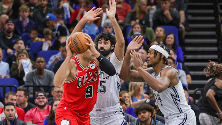Orlando Magic center Wendell Carter Jr. (34) and center Goga Bitadze (35) defend Chicago Bulls center Nikola Vucevic (9) during the first quarter at Kia Center.