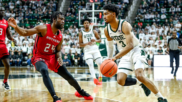 Michigan State's Jaden Akins, right, moves the ball as Rutgers' Austin Williams defends during the