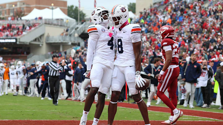 Oct 25, 2025; Fayetteville, Arkansas, USA; Auburn Tigers wide receiver Cam Coleman (8) celebrates with wide receiver Malcolm Simmons (4) after scoring a touchdown defended by Arkansas Razorbacks defensive back Julian Neal (23) during the first quarter at Donald W. Reynolds Razorback Stadium. Mandatory Credit: Nelson Chenault-Imagn Images Oct 25, 2025; Fayetteville, Arkansas, USA; Auburn Tigers wide receiver Cam Coleman (8) celebrates with wide receiver Malcolm Simmons (4) after scoring a touchdown defended by Arkansas Razorbacks defensive back Julian Neal (23) during the first quarter at Donald W. Reynolds Razorback Stadium. Mandatory Credit: Nelson Chenault-Imagn Images