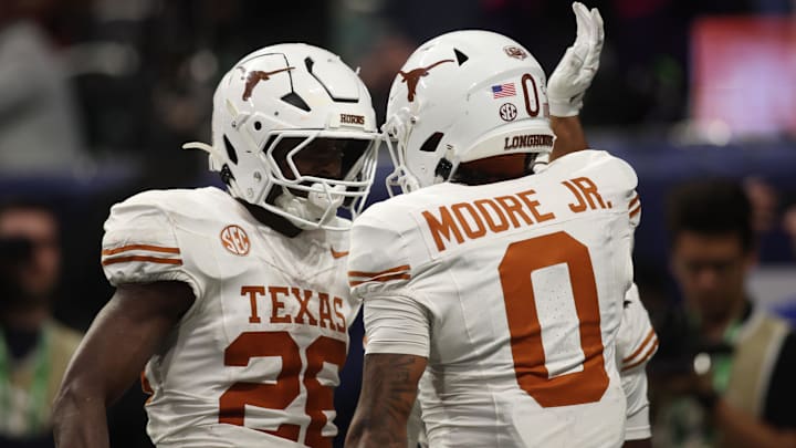 Dec 7, 2024; Atlanta, GA, USA; Texas Longhorns wide receiver DeAndre Moore Jr. (0) reacts after making a touchdown catch against the Georgia Bulldogs during the second half in the 2024 SEC Championship game at Mercedes-Benz Stadium. Mandatory Credit: Brett Davis-Imagn Images
