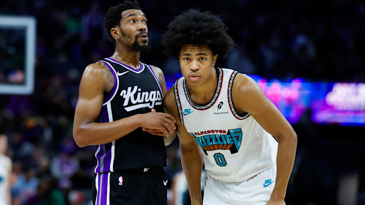 Mar 17, 2025; Sacramento, California, USA; Sacramento Kings guard Malik Monk (0) is defended by Memphis Grizzlies forward Jaylen Wells (0) during the fourth quarter at Golden 1 Center. Mandatory Credit: Sergio Estrada-Imagn Images