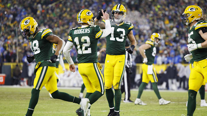 Jan 8, 2023; Green Bay, Wisconsin, USA;  Green Bay Packers quarterback Aaron Rodgers (12) celebrates with wide receiver Allen Lazard (13) following a touchdown during the third quarter against the Detroit Lions at Lambeau Field.