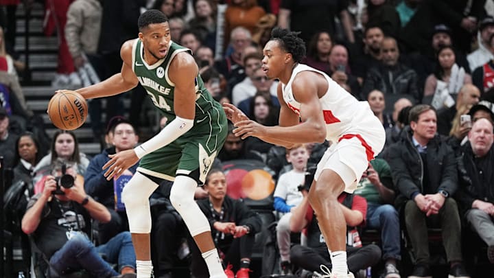 Jan 6, 2025; Toronto, Ontario, CAN; Milwaukee Bucks forward Giannis Antetokounmpo (34) controls the ball as Toronto Raptors forward Scottie Barnes (4) defends during the third quarter at Scotiabank Arena. Mandatory Credit: Nick Turchiaro-Imagn Images
