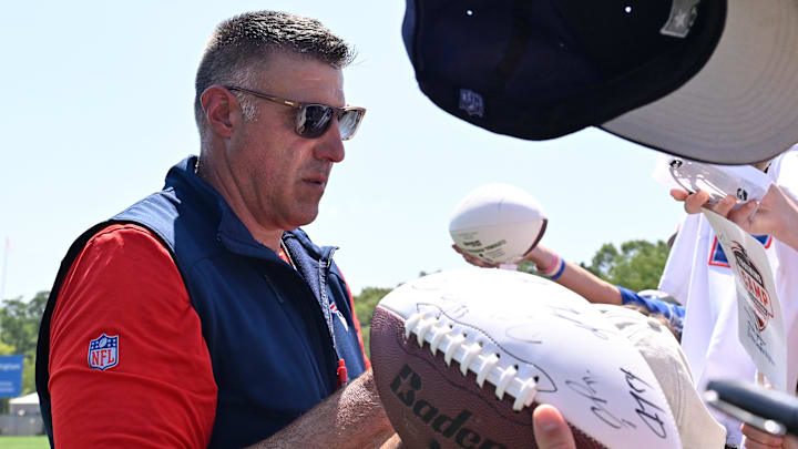 Jul 28, 2025; Foxborough, MA, USA; New England Patriots head coach Mike Vrabel signs an autograph after training camp at Gillette Stadium. Mandatory Credit: Eric Canha-Imagn Images