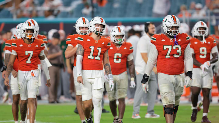 Sep 20, 2025; Miami Gardens, Florida, USA; Miami Hurricanes quarterback Carson Beck (11) and his teammates walk toward the line of scrimmage against the Florida Gators during the fourth quarter at Hard Rock Stadium. Mandatory Credit: Sam Navarro-Imagn Images