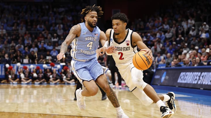Mar 18, 2025; Dayton, OH, USA; San Diego State Aztecs guard Nick Boyd (2) dribbles the ball defense dry North Carolina Tar Heels guard RJ Davis (4) in the first half at UD Arena. Mandatory Credit: Rick Osentoski-Imagn Images