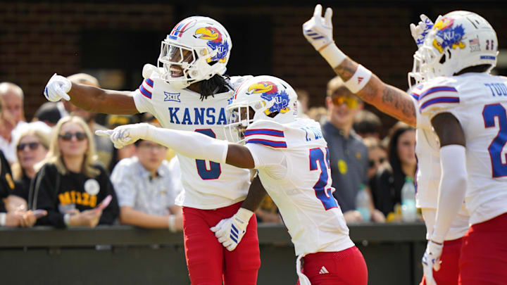Sep 6, 2025; Columbia, Missouri, USA; Kansas Jayhawks defensive back Austin Alexander (0) celebrates with teammates after recovering a fumble for a touchdown during the first half against the Missouri Tigers at Faurot Field at Memorial Stadium. Mandatory Credit: Jay Biggerstaff-Imagn Images Sep 6, 2025; Columbia, Missouri, USA; Kansas Jayhawks defensive back Austin Alexander (0) celebrates with teammates after recovering a fumble for a touchdown during the first half against the Missouri Tigers at Faurot Field at Memorial Stadium. Mandatory Credit: Jay Biggerstaff-Imagn Images