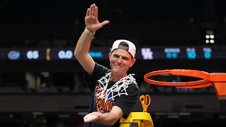 Apr 7, 2025; San Antonio, TX, USA; Florida Gators head coach Todd Golden reacts after cutting down a piece of the net after winning the national championship game of the Final Four of the 2025 NCAA Tournament at the Alamodome. Mandatory Credit: Bob Donnan-Imagn Images