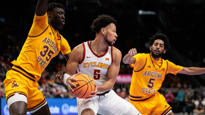 Mar 11, 2026; Kansas City, MO, USA; Iowa State Cyclones forward Joshua Jefferson (5) protects the ball from Arizona State Sun Devils center Massamba Diop (35) during the first half at T-Mobile Center. Mandatory Credit: William Purnell-Imagn Images