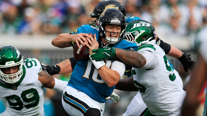Jacksonville Jaguars quarterback Mac Jones (10) steps up in the pocket to run as pressured by New York Jets defensive tackle Quinnen Williams (95) during the second quarter Sunday, Dec. 15, 2024 at EverBank Stadium in Jacksonville, Fla. [Corey Perrine/Florida Times-Union]