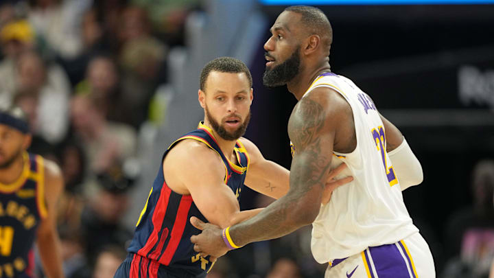 Jan 25, 2025; San Francisco, California, USA; Golden State Warriors guard Stephen Curry (left) defends against Los Angeles Lakers forward LeBron James (right) during the fourth quarter at Chase Center. Mandatory Credit: Darren Yamashita-Imagn Images