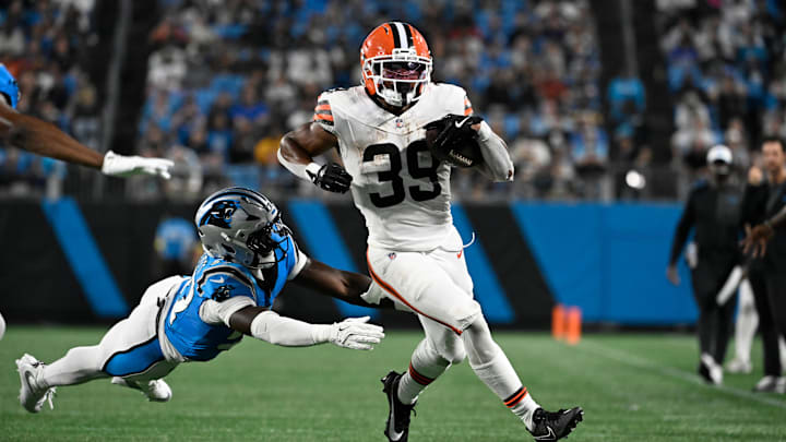 Aug 8, 2025; Charlotte, North Carolina, USA;  Cleveland Browns running back Ahmani Marshall (39) with the ball as Carolina Panthers linebacker Bam Martin-Scott (57) defends in the third quarter at Bank of America Stadium. Mandatory Credit: Bob Donnan-Imagn Images