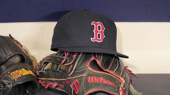 May 27, 2025; Milwaukee, Wisconsin, USA; A Boston Red Sox hat and glove sit in the dug out before a game against the Milwaukee Brewers at American Family Field. Mandatory Credit: Michael McLoone-Imagn Images