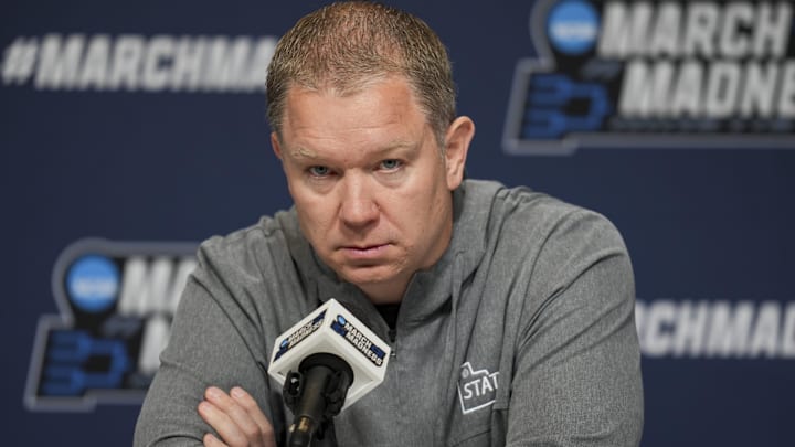 Mar 19, 2025; Lexington, KY, USA;  Utah State head coach Jerrod Calhoun talks with media during NCAA Tournament First Round Practice at Rupp Arena. Mandatory Credit: Aaron Doster-Imagn Images