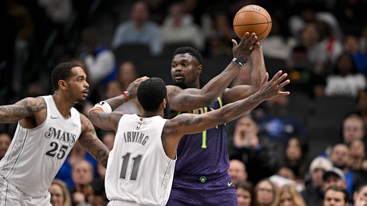 Feb 21, 2025; Dallas, Texas, USA; New Orleans Pelicans forward Zion Williamson (1) looks to pass the ball over Dallas Mavericks forward P.J. Washington (25) and guard Kyrie Irving (11) during the second half at the American Airlines Center. Mandatory Credit: Jerome Miron-Imagn Images