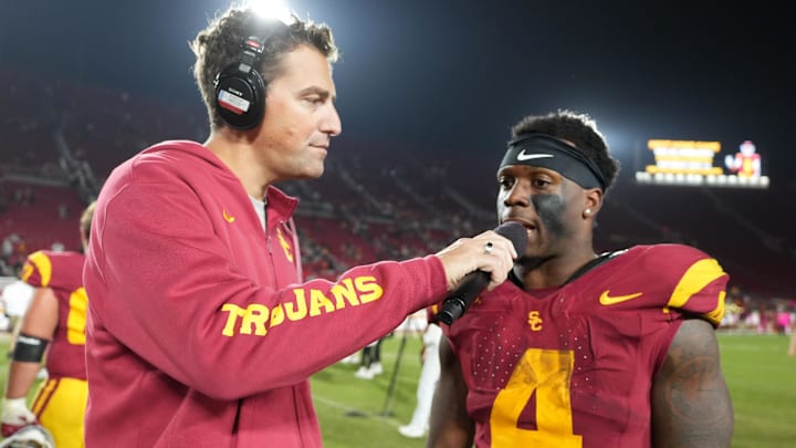 Oct 25, 2024; Los Angeles, California, USA; Jordan Moore interviews Southern California Trojans running back Woody Marks (4) after the game against the Rutgers Scarlet Knights at United Airlines Field at Los Angeles Memorial Coliseum. Mandatory Credit: Kirby Lee-Imagn Images