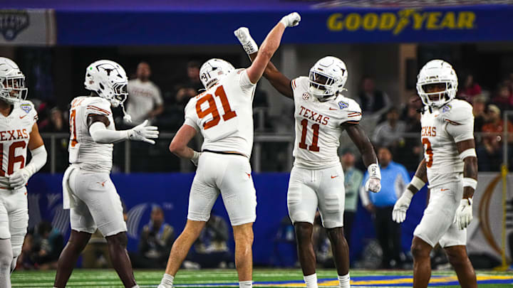 Texas Longhorns edge rushers Colin Simmons (11) and Ethan Burke (91) celebrate a sack during the College Football Playoff semifinal game against Ohio State in the Cotton Bowl at AT&T Stadium on Friday, Jan. 10, 2024 in Arlington, Texas. Texas Longhorns edge rushers Colin Simmons (11) and Ethan Burke (91) celebrate a sack during the College Football Playoff semifinal game against Ohio State in the Cotton Bowl at AT&T Stadium on Friday, Jan. 10, 2024 in Arlington, Texas.