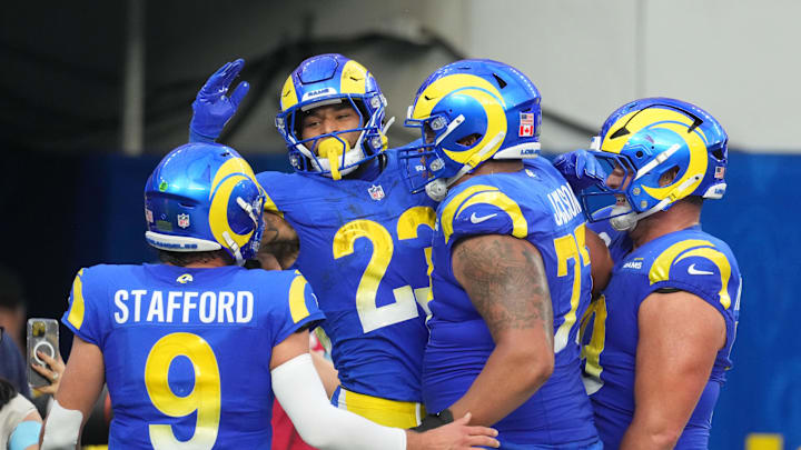 Dec 8, 2024; Inglewood, California, USA; Los Angeles Rams running back Kyren Williams (23) celebrates with quarterback Matthew Stafford (9) and offensive tackle Alaric Jackson (77) after scoring in a 7-yard touchdown run against the Buffalo Bills in the third quarter at SoFi Stadium. Mandatory Credit: Kirby Lee-Imagn Images