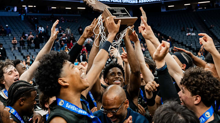 Brandon McCoy Jr. (middle) hoists the CIF State trophy up in celebration with his teammates after beating Salesian Prep 78-70 in the Open final at the Golden 1 Center in Sacramento.