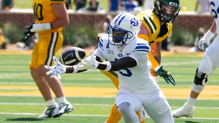 Sep 28, 2024; Waco, Texas, USA;  Brigham Young Cougars wide receiver Darius Lassiter (5) makes a catch against Baylor Bears linebacker Matt Jones (2) during the second half at McLane Stadium.