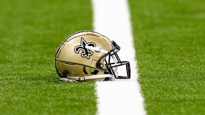 Aug 25, 2024; New Orleans, Louisiana, USA;  New Orleans Saints helmet on the turf during warmups before the game against the Tennessee Titans at Caesars Superdome. Mandatory Credit: Stephen Lew-Imagn Images