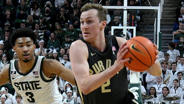 Purdue Boilermakers guard Fletcher Loyer (2) drives past Michigan State Spartans guard Jaden Akins (3) 