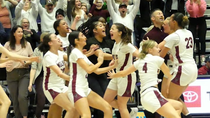The Tualatin girls basketball team celebrates the first OSAA Class 6A state championship in program history.