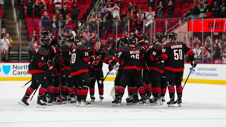 Apr 12, 2025; Raleigh, North Carolina, USA;  Carolina Hurricanes players celebrate there victory against the New York Rangers at Lenovo Center. Mandatory Credit: James Guillory-Imagn Images