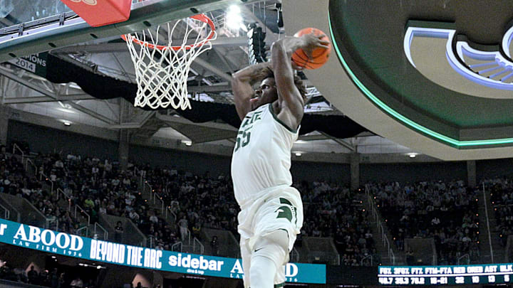 Nov 21, 2025; East Lansing, Michigan, USA;  Michigan State Spartans forward Coen Carr (55) drives home a dunk on a lob pass from a teammate during the second half against the Detroit Mercy Titans at Jack Breslin Student Events Center. Mandatory Credit: Dale Young-Imagn Images