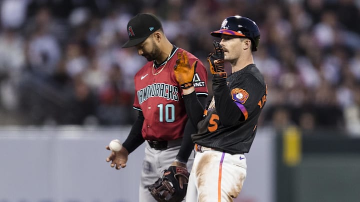 May 13, 2025; San Francisco, California, USA; Arizona Diamondbacks shortstop Jordan Lawlar (10) tosses the ball as San Francisco Giants right fielder Mike Yastrzemski (5) reacts after hitting a double during the fourth inning at Oracle Park. Mandatory Credit: John Hefti-Imagn Images May 13, 2025; San Francisco, California, USA; Arizona Diamondbacks shortstop Jordan Lawlar (10) tosses the ball as San Francisco Giants right fielder Mike Yastrzemski (5) reacts after hitting a double during the fourth inning at Oracle Park. Mandatory Credit: John Hefti-Imagn Images
