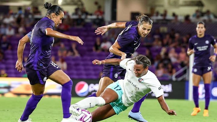 Jun 24, 2023; Orlando, Florida, USA; Kansas City Current forward Michelle Cooper (17) attempts controls the ball as Orlando Pride defender Kylie Strom (3) and forward Marta (10) defend at Exploria Stadium. Mandatory Credit: Nathan Ray Seebeck-USA TODAY Sports