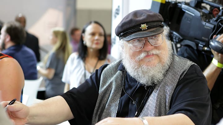Writer George R.R. Martin of "Game of Thrones" signs autographs during the 2014 Comic-Con International Convention.