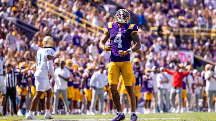 Sep 21, 2024; Baton Rouge, Louisiana, USA;  LSU Tigers wide receiver CJ Daniels (4) reacts after missing a pass against UCLA Bruins defensive back Ramon Henderson (11) during the first half at Tiger Stadium. Mandatory Credit: Stephen Lew-Imagn Images