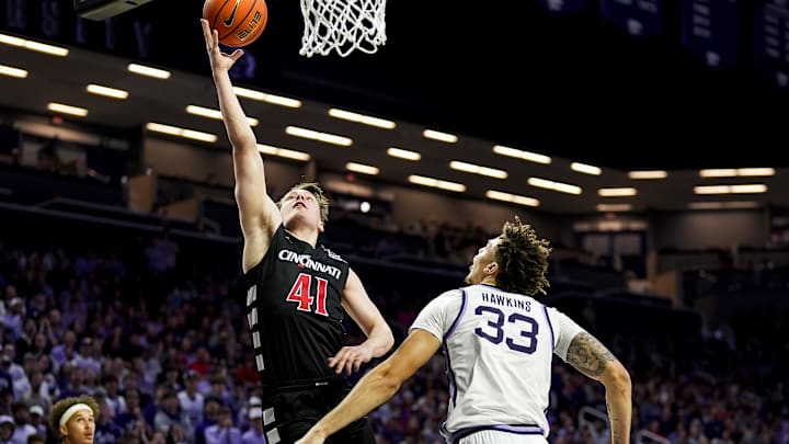 Dec 30, 2024; Manhattan, Kansas, USA; Cincinnati Bearcats guard Simas Lukosius (41) shoots against Kansas State Wildcats guard Coleman Hawkins (33) during the first half at Bramlage Coliseum. Mandatory Credit: Jay Biggerstaff-Imagn Images Dec 30, 2024; Manhattan, Kansas, USA; Cincinnati Bearcats guard Simas Lukosius (41) shoots against Kansas State Wildcats guard Coleman Hawkins (33) during the first half at Bramlage Coliseum. Mandatory Credit: Jay Biggerstaff-Imagn Images