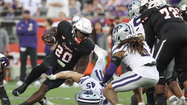 Nov 2, 2024; Houston, Texas, USA; Houston Cougars running back J'Marion Burnette (20) runs the ball against Kansas State Wildcats linebacker Austin Romaine (45) in the second quarter at TDECU Stadium. Mandatory Credit: Thomas B. Shea-Imagn Images Nov 2, 2024; Houston, Texas, USA; Houston Cougars running back J'Marion Burnette (20) runs the ball against Kansas State Wildcats linebacker Austin Romaine (45) in the second quarter at TDECU Stadium. Mandatory Credit: Thomas B. Shea-Imagn Images