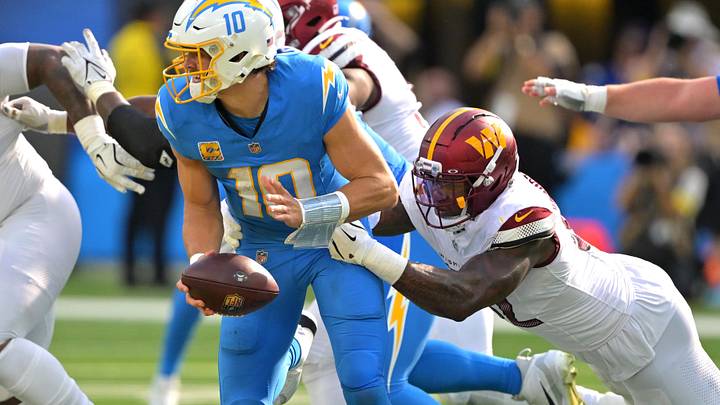 Oct 5, 2025; Inglewood, California, USA; Washington Commanders defensive end Dorance Armstrong (92) sacks Los Angeles Chargers quarterback Justin Herbert (10) in the second half at SoFi Stadium. Mandatory Credit: Jayne Kamin-Oncea-Imagn Images