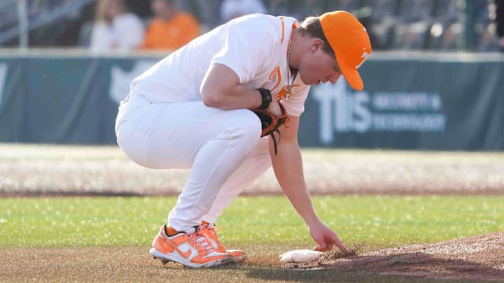 Tennessee pitcher Liam Doyle (12) marks in the dirt at the Tennessee baseball season opener against Hofstra, in Lindsey Nelson Stadium at University of Tennessee in Knoxville, Tenn., Friday, February. 14, 2025.