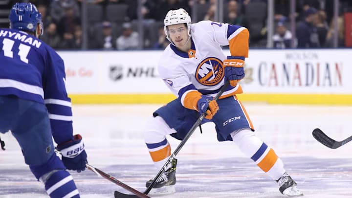Feb 22, 2018; Toronto, Ontario, CAN; New York Islanders center Mathew Barzal (13) skates with the puck against the Toronto Maple Leafs at Air Canada Centre. The Maple Leafs beat the Islanders 4-3 in the shootout. Mandatory Credit: Tom Szczerbowski-Imagn Images