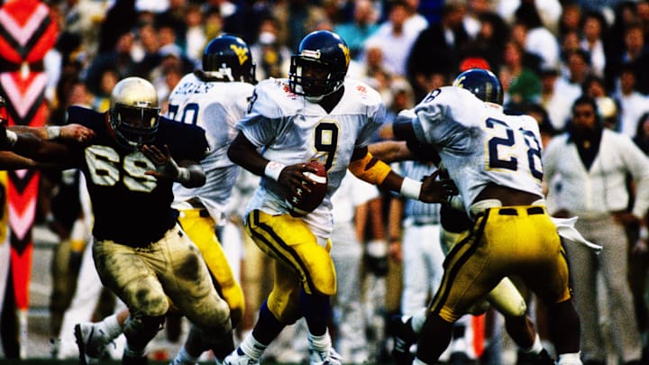 Jan 2, 1989; Tempe, AZ, USA; FILE PHOTO; Notre Dame Irish defensive tackle George Williams (69) pressures West Virginia Mountaineers quarterback Major Harris (9) during the 1989 National Championship Fiesta Bowl at Sun Devil Stadium. Notre Dame defeated West Virginia 34-21. Mandatory Credit: Malcolm Emmons-USA TODAY NETWORK