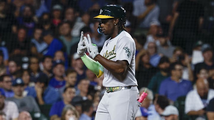Sep 17, 2024; Chicago, Illinois, USA; Oakland Athletics outfielder Lawrence Butler (4) celebrates as he crosses home plate after hitting a solo home run against the Chicago Cubs during the third inning at Wrigley Field. Mandatory Credit: Kamil Krzaczynski-Imagn Images