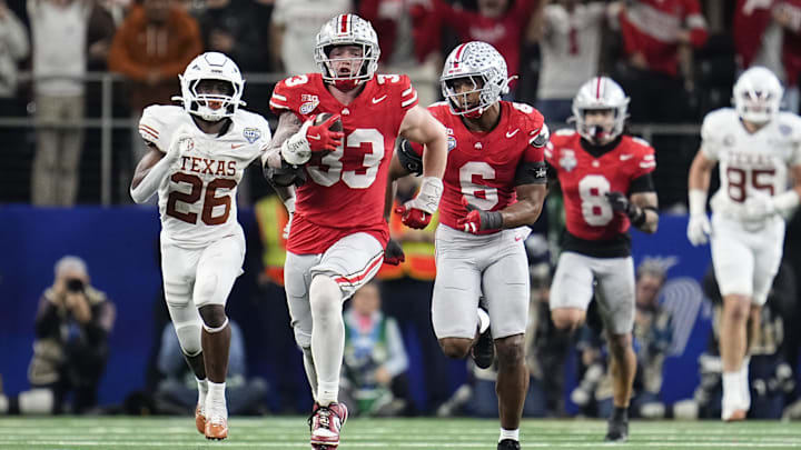 Ohio State Buckeyes defensive end Jack Sawyer (33) returns a fumble recovery for a touchdown after sacking Texas Longhorns quarterback Quinn Ewers (3) during the second half of the Cotton Bowl Classic College Football Playoff semifinal game at AT&T Stadium in Arlington, Texas on Jan. 10, 2025. Sawyer returned the fumble for a touchdown, and Ohio State won 28-14.