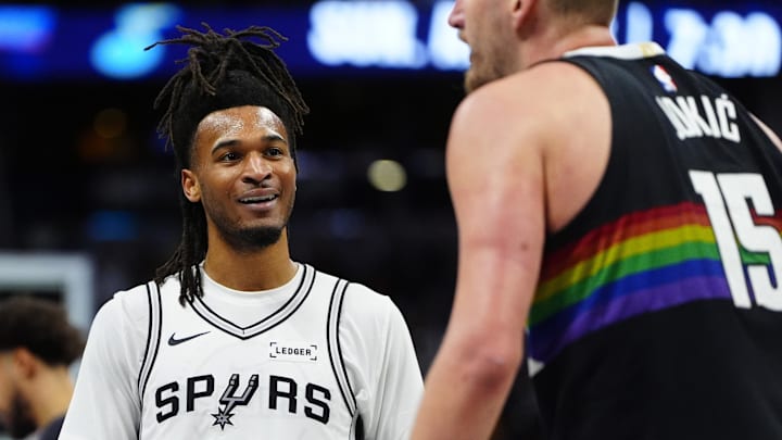 Apr 4, 2026; Denver, Colorado, USA; San Antonio Spurs guard Stephon Castle (5) reacts towards Denver Nuggets center Nikola Jokic (15) in the third quarter at Ball Arena. Mandatory Credit: Ron Chenoy-Imagn Images