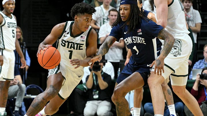 Jan 15, 2025; East Lansing, Michigan, USA;  Michigan State Spartans guard Jeremy Fears Jr. (1) drives past Penn State Nittany Lions guard Ace Baldwin Jr. (1) during the first half at Jack Breslin Student Events Center. Mandatory Credit: Dale Young-Imagn Images