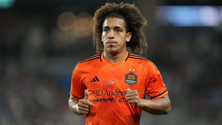 Apr 13, 2024; Saint Paul, Minnesota, USA; Houston Dynamo FC midfielder Coco Carrasquilla (20) jogs on the field during the second half against Minnesota United at Allianz Field. Mandatory Credit: Brace Hemmelgarn-USA TODAY Sports