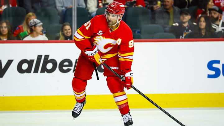 Oct 26, 2025; Calgary, Alberta, CAN; Calgary Flames center Nazem Kadri (91) controls the puck against the New York Rangers during the second period at Scotiabank Saddledome. Mandatory Credit: Sergei Belski-Imagn Images Oct 26, 2025; Calgary, Alberta, CAN; Calgary Flames center Nazem Kadri (91) controls the puck against the New York Rangers during the second period at Scotiabank Saddledome. Mandatory Credit: Sergei Belski-Imagn Images