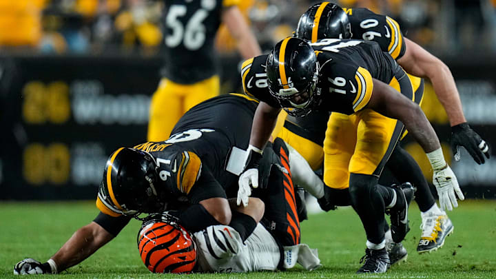 Cincinnati Bengals quarterback Jake Browning (6) is sacked by Pittsburgh Steelers defensive tackle Cameron Heyward (97) in the fourth quarter of the NFL 16 game between the Pittsburgh Steelers and the Cincinnati Bengals at Acrisure Stadium in Pittsburgh on Saturday, Dec. 23, 2023. The Steelers won 34-11.