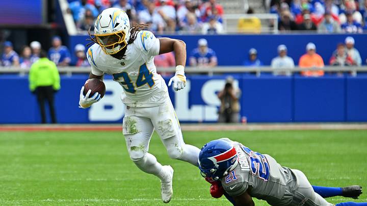 Sep 27, 2026; Orchard Park, New York, USA;  Los Angeles Chargers running back Keaton Mitchell (34) is tackled by Buffalo Bills cornerback Davison Igbinosun (21) in the second half at New Highmark Stadium.  Mandatory Credit: Mark Konezny-Imagn Images