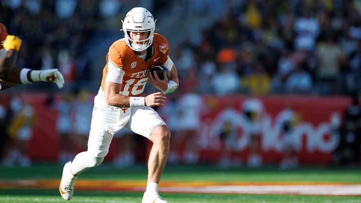 Dec 31, 2025; Orlando, FL, USA; Texas Longhorns quarterback Arch Manning (16) runs with the ball against the Michigan Wolverines Dec 31, 2025; Orlando, FL, USA; Texas Longhorns quarterback Arch Manning (16) runs with the ball against the Michigan Wolverines